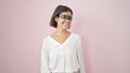 Young beautiful hispanic woman using virtual reality smiling over isolated pink background Royalty Free Stock Photo