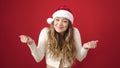 Young beautiful hispanic woman wearing christmas hat doing i dont know gesture at street Royalty Free Stock Photo