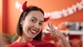 Young beautiful hispanic woman wearing devil costume make selfie by camera at home Royalty Free Stock Photo