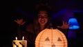 Young beautiful hispanic woman wearing katrina costume doing incantation at home