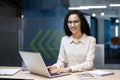 Young beautiful hispanic woman working inside modern office, businesswoman smiling and looking at camera at work using Royalty Free Stock Photo
