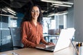 Young beautiful hispanic woman working inside modern office, businesswoman smiling and looking at camera at work using Royalty Free Stock Photo