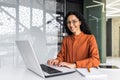 Young beautiful hispanic woman working inside modern office, businesswoman smiling and looking at camera at work using Royalty Free Stock Photo