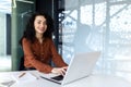 Young beautiful hispanic woman working inside modern office, businesswoman smiling and looking at camera at work using Royalty Free Stock Photo