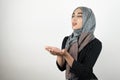 Young beautiful hopeful Muslim woman wearing turban hijab, headscarf holding her hands together standing with closed Royalty Free Stock Photo