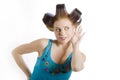 Young beautiful housewife with hair curlers