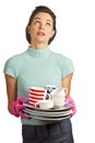 Young beautiful housewife with pile of dishes