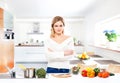 Young and beautiful housewife woman cooking in a kitchen Royalty Free Stock Photo