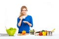 Young and beautiful housewife woman cooking in a kitchen Royalty Free Stock Photo