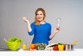 Young and beautiful housewife woman cooking in a kitchen Royalty Free Stock Photo