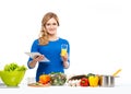 Young and beautiful housewife woman cooking in a kitchen Royalty Free Stock Photo