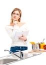 Young and beautiful housewife woman cooking in a kitchen Royalty Free Stock Photo