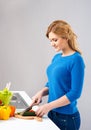 Young and beautiful housewife woman cooking in a kitchen Royalty Free Stock Photo