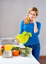 Young and beautiful housewife woman cooking in a kitchen Royalty Free Stock Photo