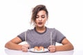 Young beautiful hungry woman holding sushi with chopsticks isolated on white background Royalty Free Stock Photo