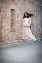 Young beautiful Indian Woman standing against stone wall outdoors