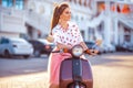 Young beautiful italian woman sitting on a italian scooter Royalty Free Stock Photo