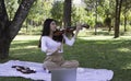Young beautiful lady playing violin in a park.relax time Royalty Free Stock Photo