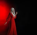 Young beautiful lady woman image goddess death. Blonde long hair. vintage dress. Backdrop red light black free space for Royalty Free Stock Photo