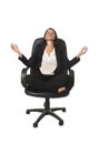 Young beautiful latin american business woman sitting at office chair in lotus posture practicing yoga Royalty Free Stock Photo