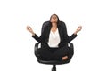 Young beautiful latin american business woman sitting at office chair in lotus posture practicing yoga Royalty Free Stock Photo