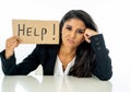 Young beautiful latin business woman overwhelmed and tired holding a help sign. looking Stressed, bored, frustrated, upset and Royalty Free Stock Photo