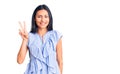 Young beautiful latin girl wearing casual clothes smiling looking to the camera showing fingers doing victory sign Royalty Free Stock Photo