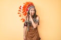 Young beautiful latin girl wearing indian costume hand on mouth telling secret rumor, whispering malicious talk conversation Royalty Free Stock Photo
