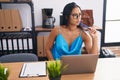 Young beautiful latin woman business worker using laptop with serious expression at office Royalty Free Stock Photo