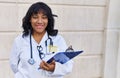 Young beautiful latin woman doctor smiling confident holding clipboard at hospital Royalty Free Stock Photo