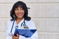 Young beautiful latin woman doctor smiling confident holding clipboard at hospital Royalty Free Stock Photo