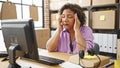 Young beautiful latin woman ecommerce business worker using computer stressed at office Royalty Free Stock Photo