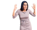 Young beautiful latin woman wearing casual clothes crazy and mad shouting and yelling with aggressive expression and arms raised Royalty Free Stock Photo