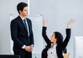 Young beautiful long black hair caucasian female successful businesswoman sitting looking and yelling at male colleague employee Royalty Free Stock Photo