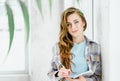 Young beautiful long haired college student girl in casual shirt with notebook, pen. Businesswoman making notes in Royalty Free Stock Photo