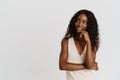 Young beautiful long-haired smiling thoughtful african woman looking aside Royalty Free Stock Photo