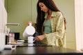 Young beautiful long-haired woman pouring hot water into a cup Royalty Free Stock Photo