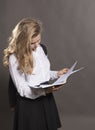 Young beautiful longhaired college girl with papers