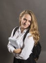 Young beautiful longhaired student girl with papers looks happy