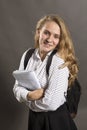 Young beautiful longhaired student girl with papers looks happy