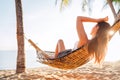 Young beautiful longhaired woman relax in hammok on the sand beach Royalty Free Stock Photo