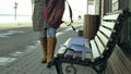 Young, beautiful, lovely woman sitting on bench in park, in hands of her notebook. She is wearing a coat. She makes Royalty Free Stock Photo