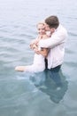 Young beautiful lovers in pool of water sharing an intimate moment Royalty Free Stock Photo