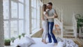 Young beautiful and loving couple dancing and kissing on bed in the morning at home Royalty Free Stock Photo