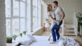 Young beautiful and loving couple dancing rocknroll dance on bed in the morning at home Royalty Free Stock Photo