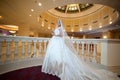 Young beautiful luxurious woman in wedding dress posing in luxurious interior. Bride with huge wedding dress in majestic manor
