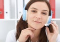 Young beautiful medical secretary with handset at hospital.