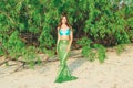 Young beautiful mermaid woman close up standing on the sea cost. Cosplay mermaid