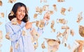 Young beautiful mixed race woman wearing casual business shirt smiling and looking at the camera pointing with two hands and Royalty Free Stock Photo