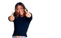 Young beautiful mixed race woman wearing casual clothes approving doing positive gesture with hand, thumbs up smiling and happy Royalty Free Stock Photo